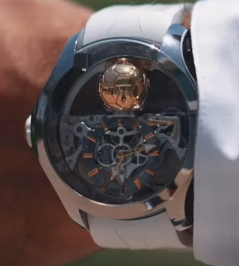 a man wears a watch with a soccer ball on the face