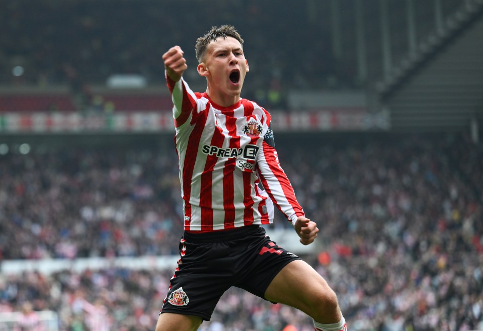 a soccer player wearing a red and white striped shirt that says ' spread e ' on it