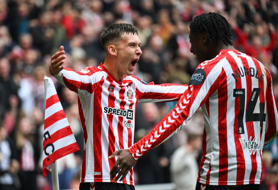 two soccer players wearing red and white striped jerseys with the word spread on them