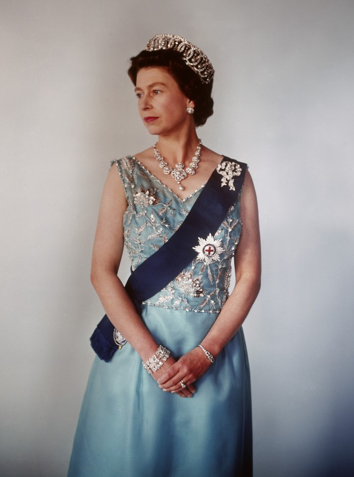 queen elizabeth wearing a blue dress and tiara