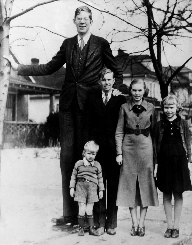 a black and white photo of a family posing for a picture