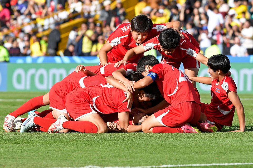 Choe Il-Son celebrates with her team-mates after netting the winner