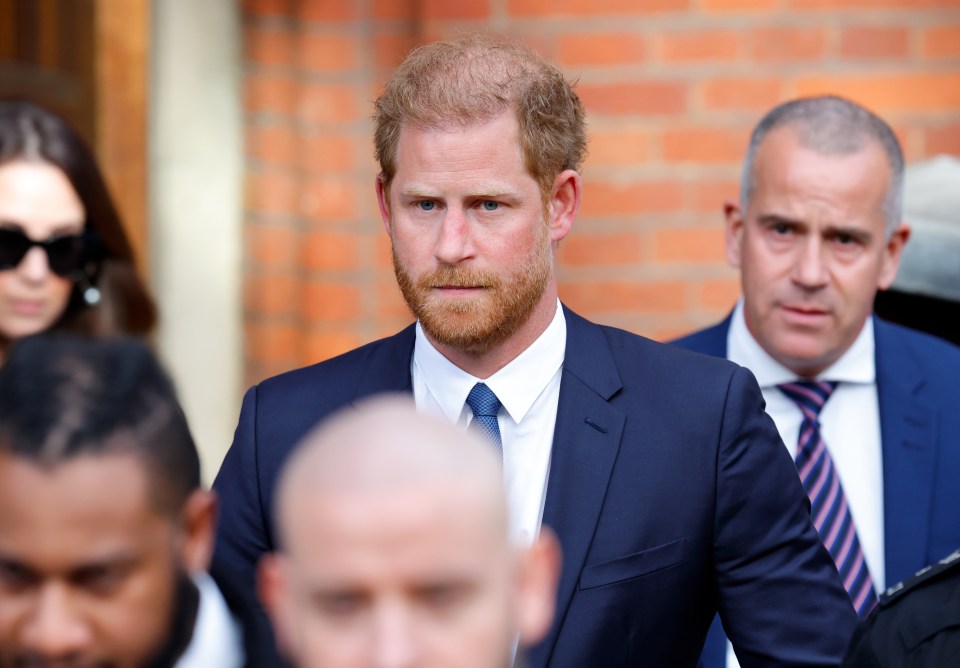 a man in a suit and tie stands in a crowd