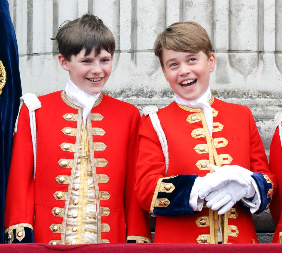 two young boys in red uniforms are smiling for the camera