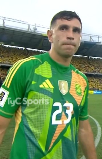 a man wearing a green jersey with the number 23 on it