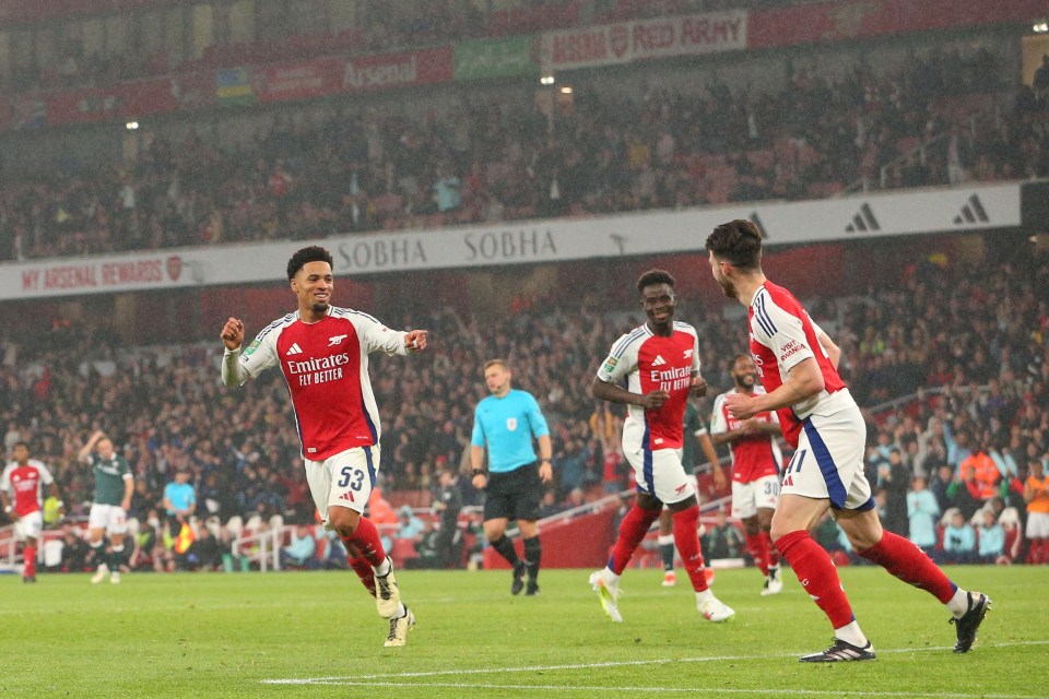 a soccer player wearing a jersey that says emirates fly better