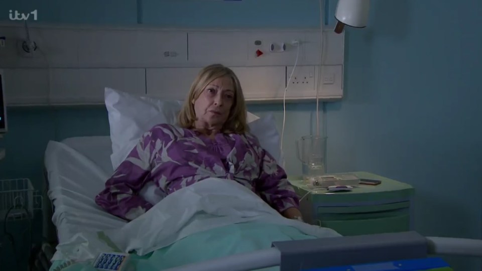 a woman in a hospital bed with itv1 written on the bottom