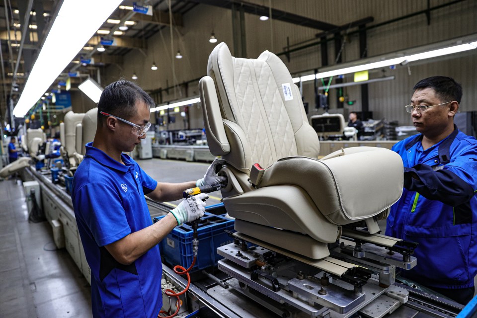 Employees work on the production line of car seats at Yanfeng (Shenyang) Seating Systems Co