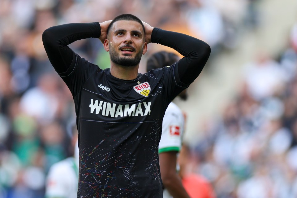 a man in a winamax jersey holds his head