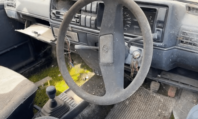 a dirty steering wheel with a vw logo on it