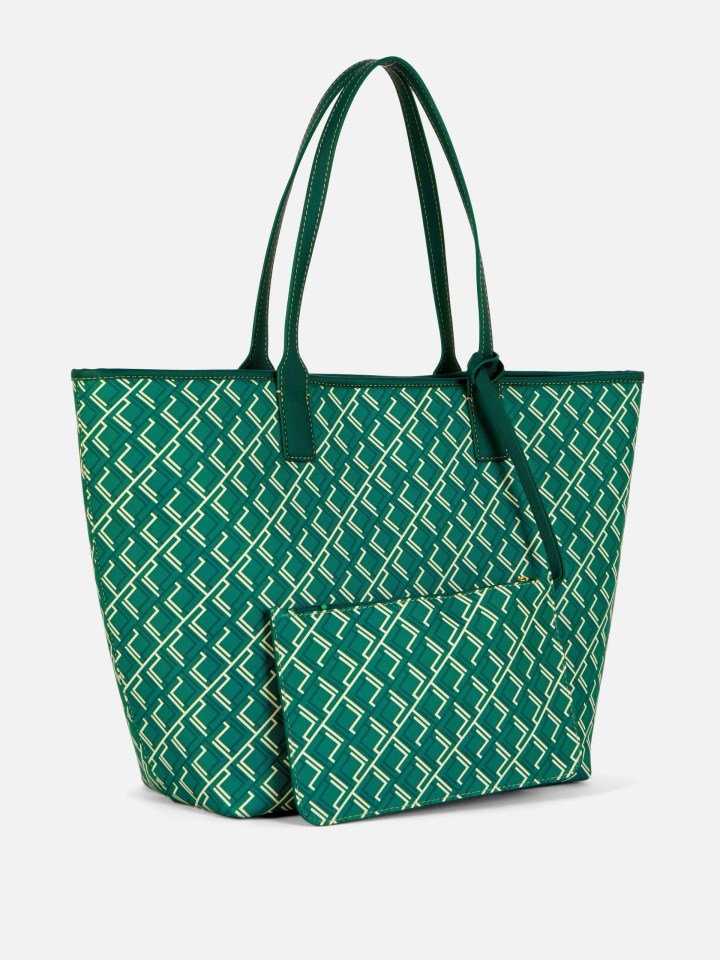 a green and white tote bag with the letter l on it