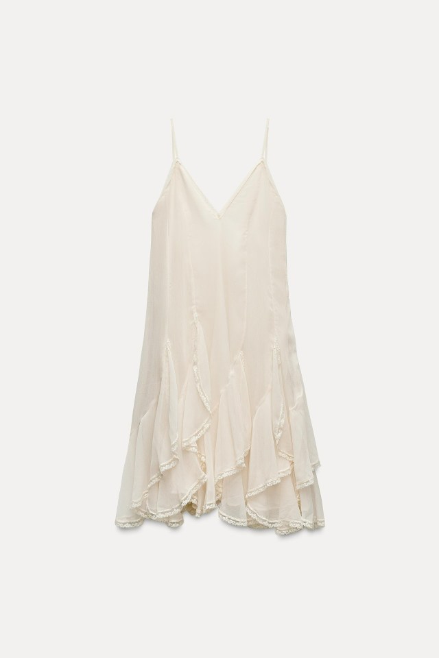 a white dress with ruffles on the bottom