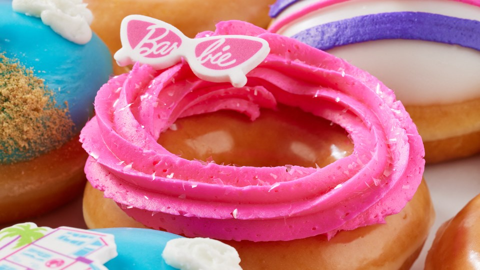 a close up of a barbie donut with pink frosting