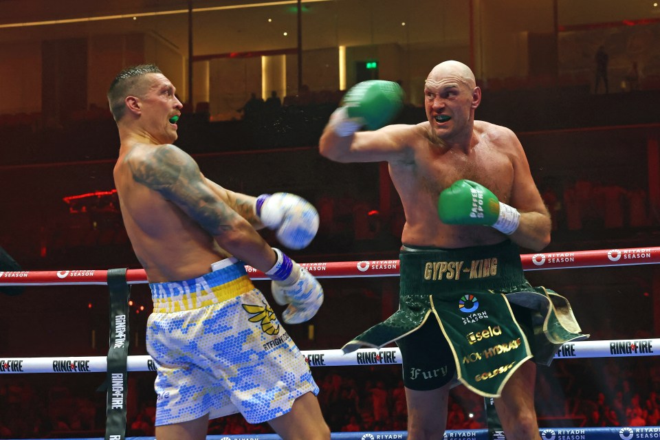 two boxers in a ring with one wearing gypsy king shorts