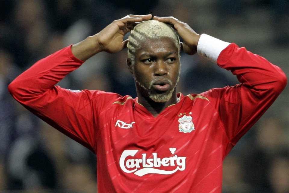 a soccer player wearing a red carlsberg jersey