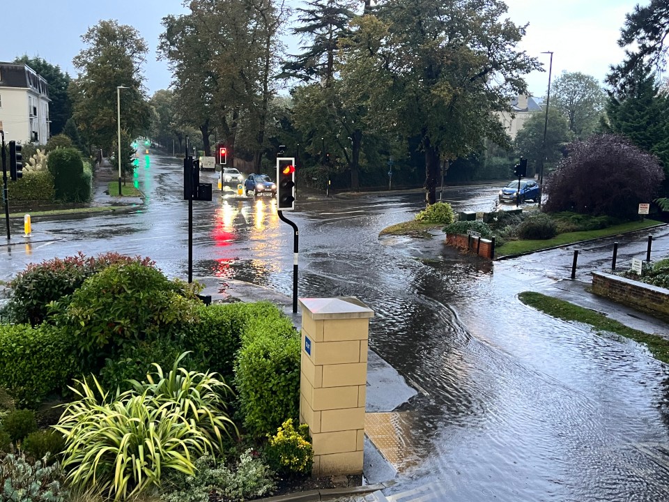 a flooded street with a sign that says no parking