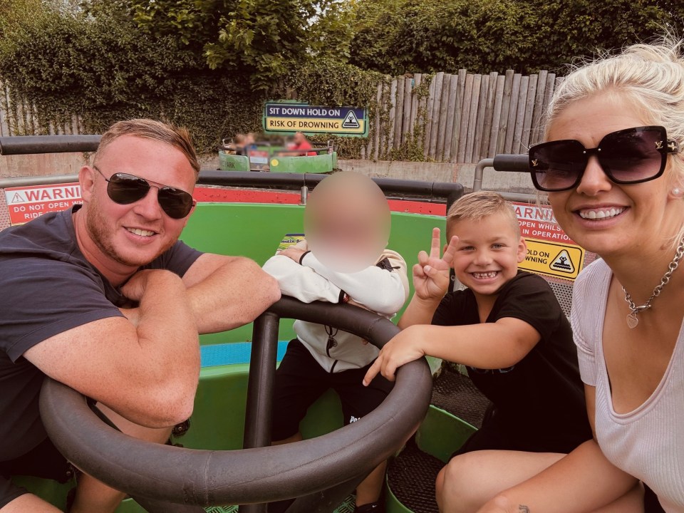 a family sits in a green vehicle with a sign that says " sit down hold on risk of drowning "