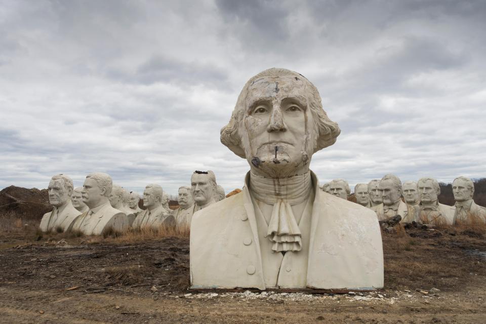 a statue of george washington is surrounded by other statues