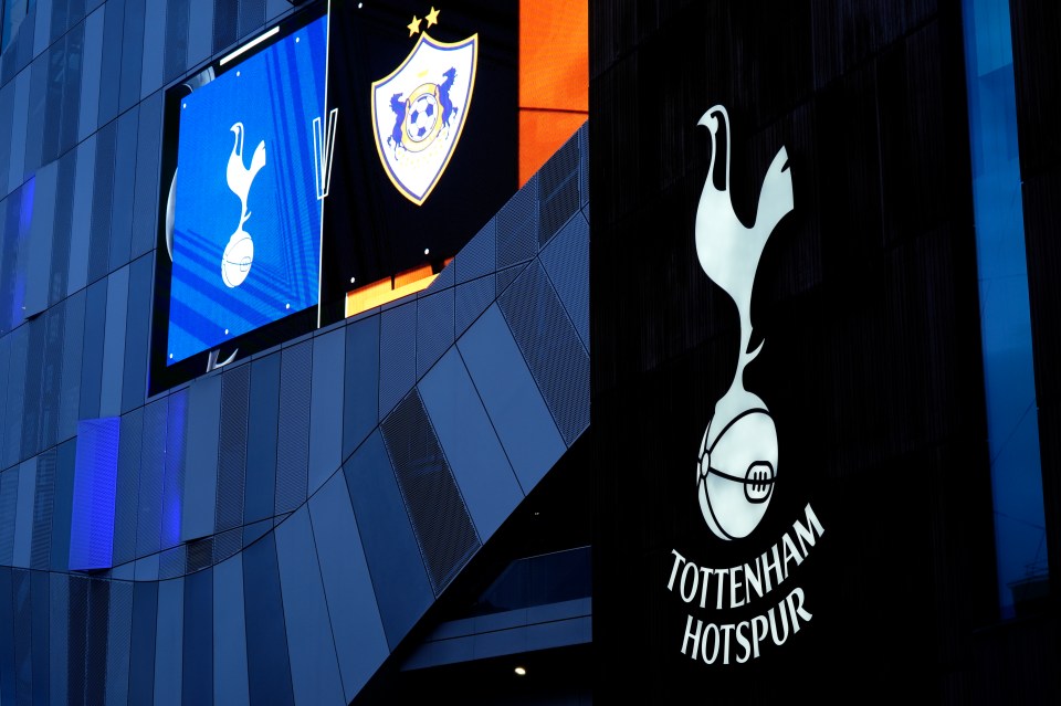 the tottenham hotspur stadium is lit up at night