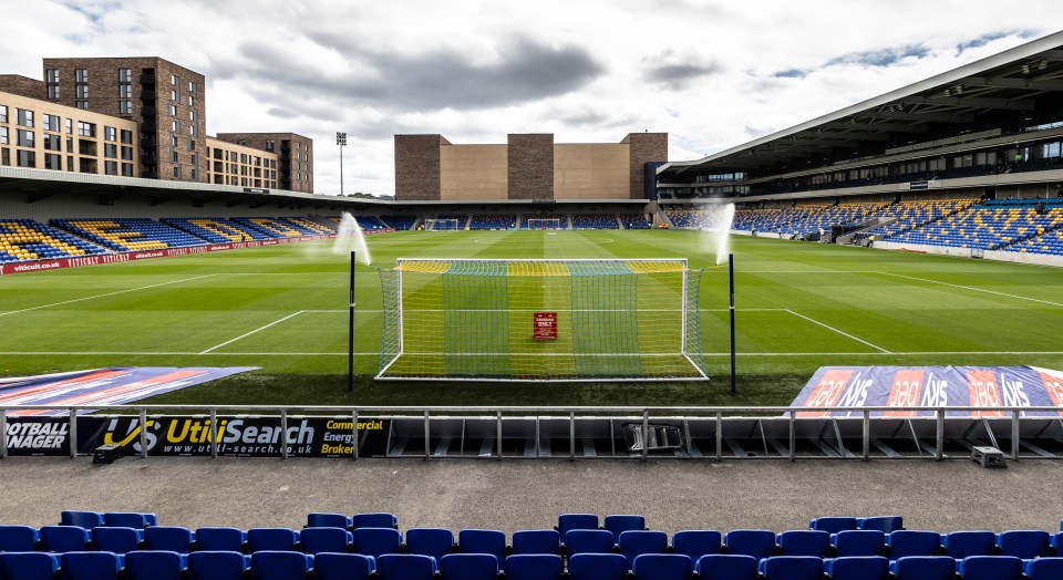 an empty soccer stadium with a banner that says utilisearch