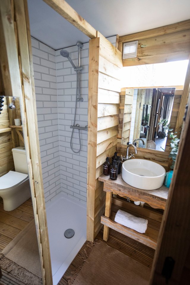 Guests have a flushing toilet and fully functional shower in the bathroom