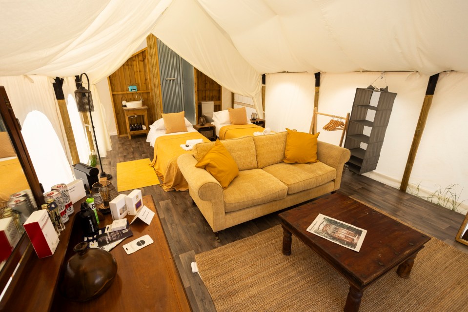 a living room with a couch and two beds