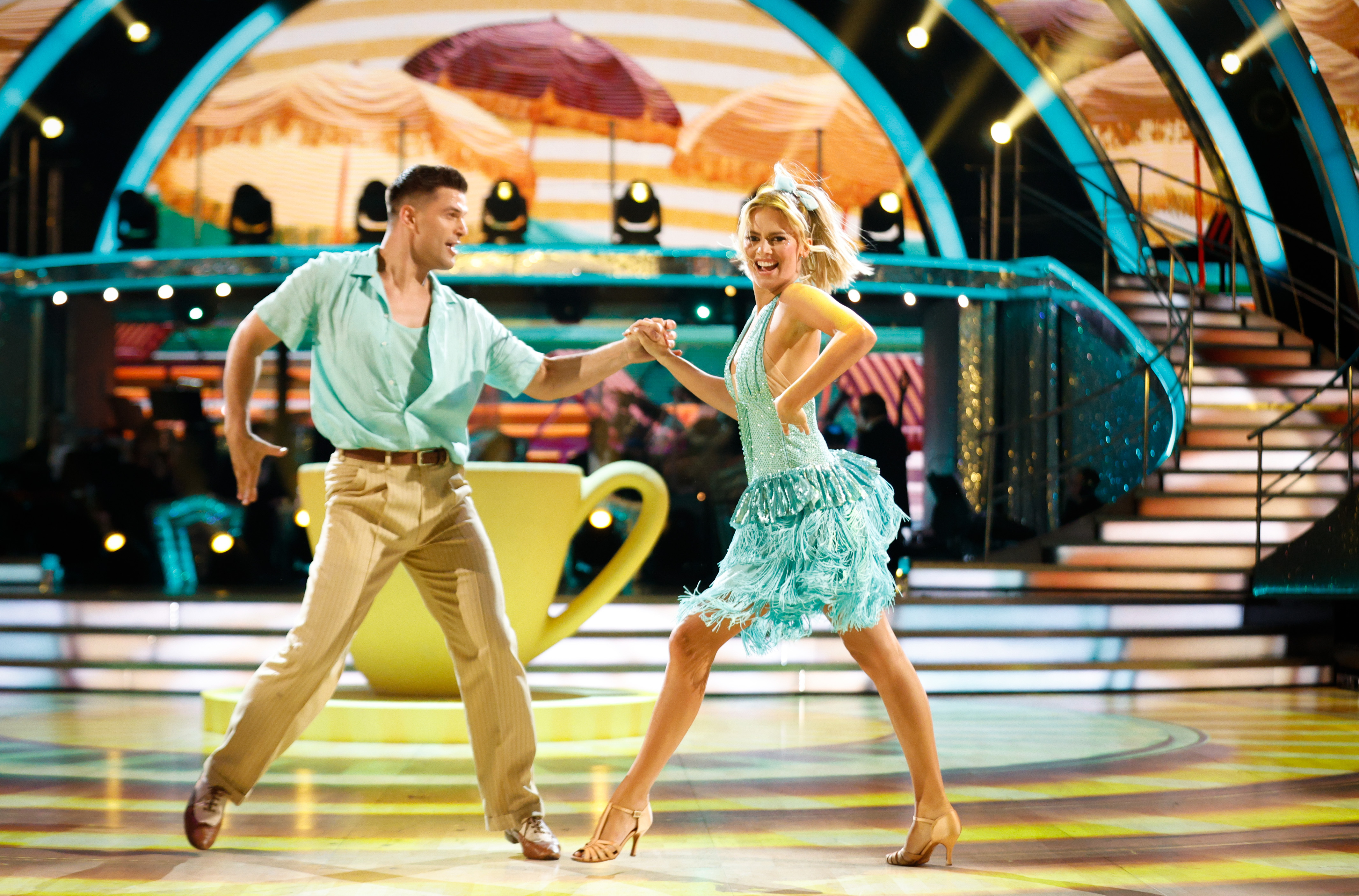 a man and a woman are dancing on a stage