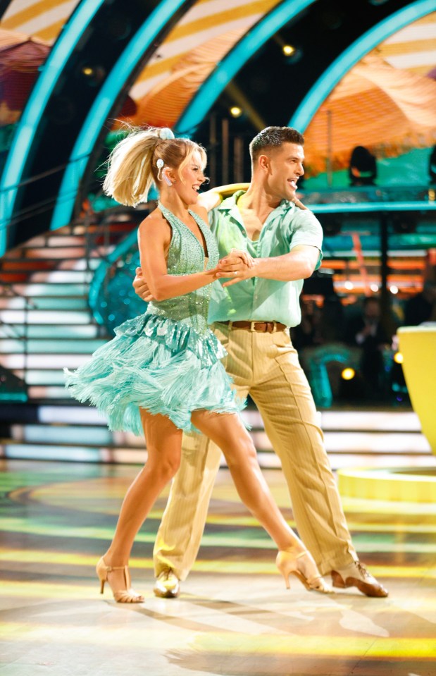 a man and a woman are dancing on a stage