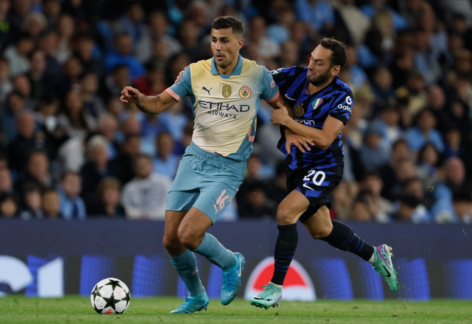 Hakan Calhanoglu is seen here getting to grips with Man City's Rodri