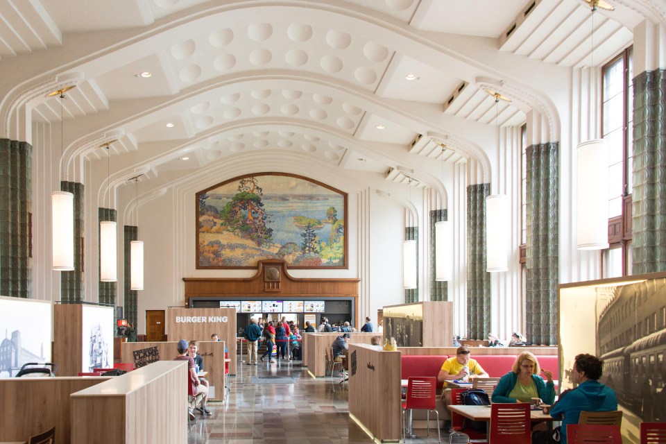 the interior of a burger king restaurant with people sitting at tables