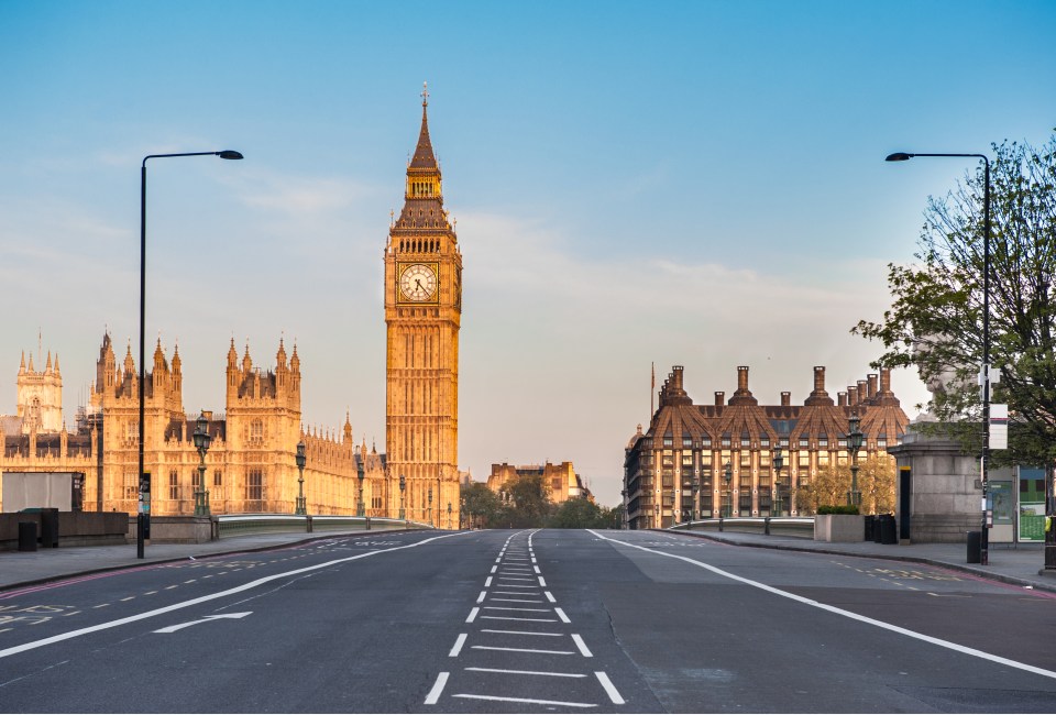 an empty street with big ben in the background