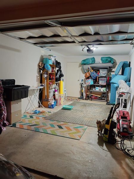 a garage filled with lots of stuff and a cat .