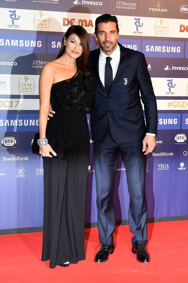 a man and a woman pose on a red carpet sponsored by samsung