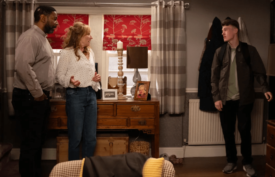 a man and two women are standing in a living room