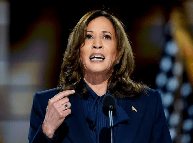 a woman with a ring on her finger is speaking into a microphone