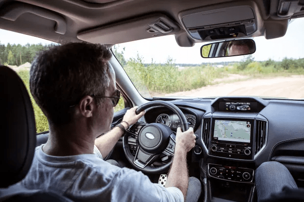 a man is driving a car with a navigation system