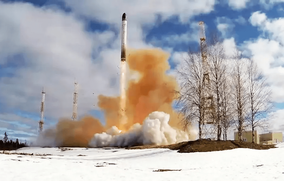 a rocket is being launched in a snowy field