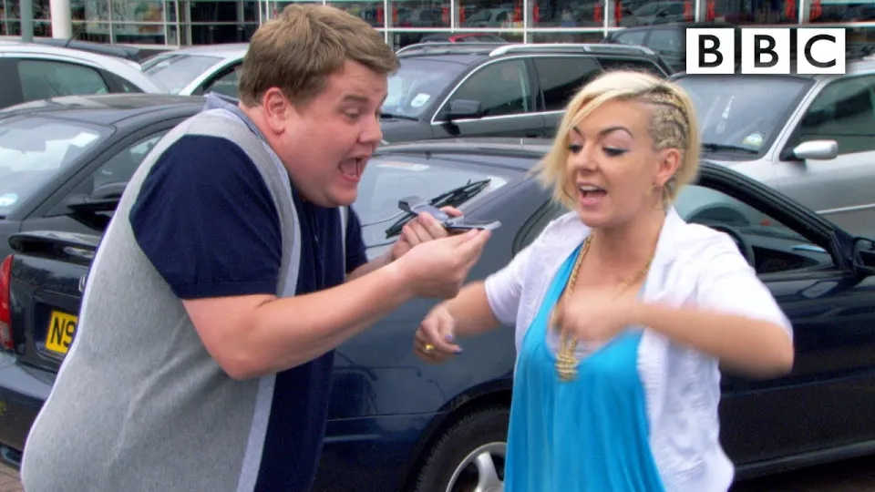 a man and a woman are standing next to a car with a license plate that says n9