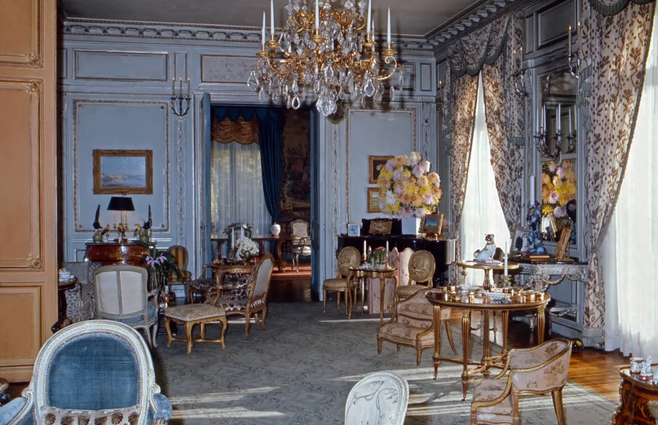 a living room filled with furniture and a chandelier