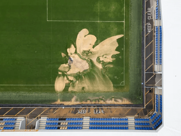 an aerial view of a soccer field that says keep clear