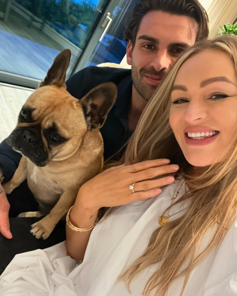 a man and woman are posing for a picture with their dog