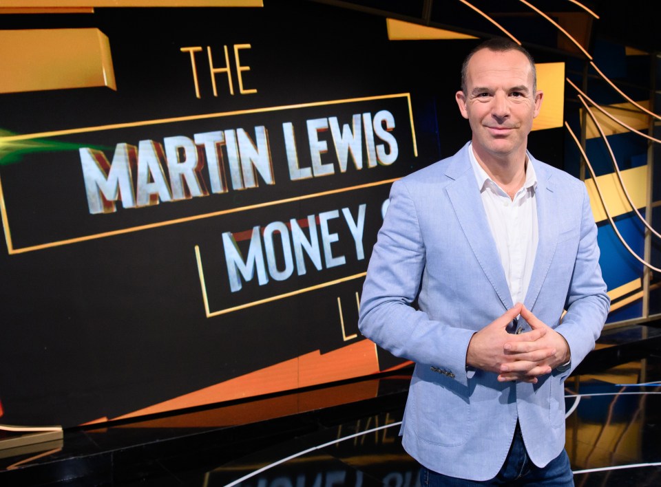 a man stands in front of a martin lewis money sign