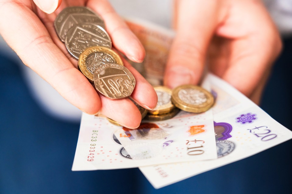 A selection of British coins with a £10 and £20 note.