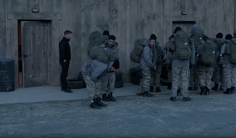 a group of soldiers are standing in front of a wooden building