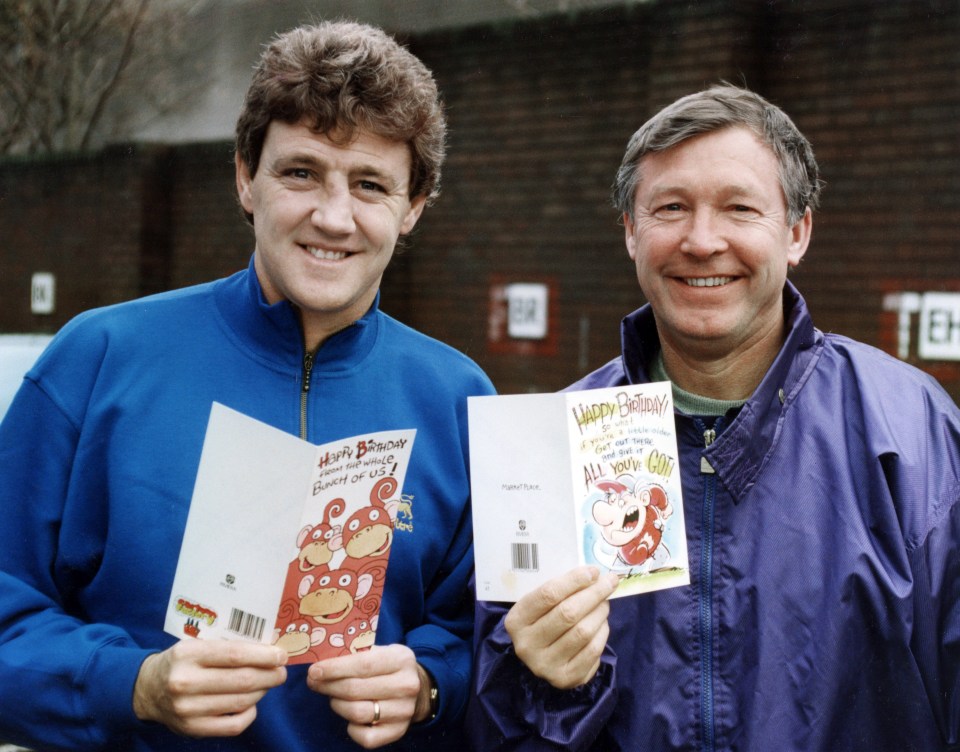 two men holding a card that says happy birthday