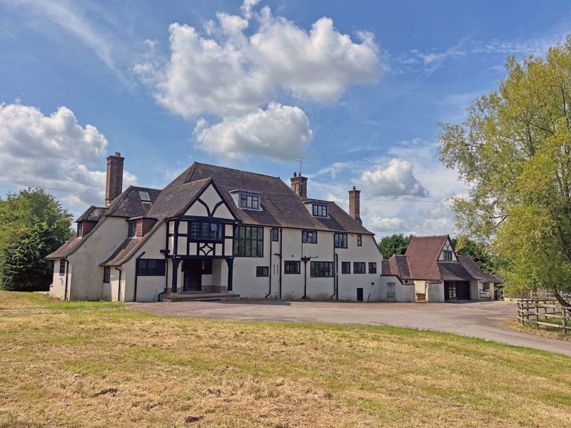 a large house with a lot of windows and chimneys