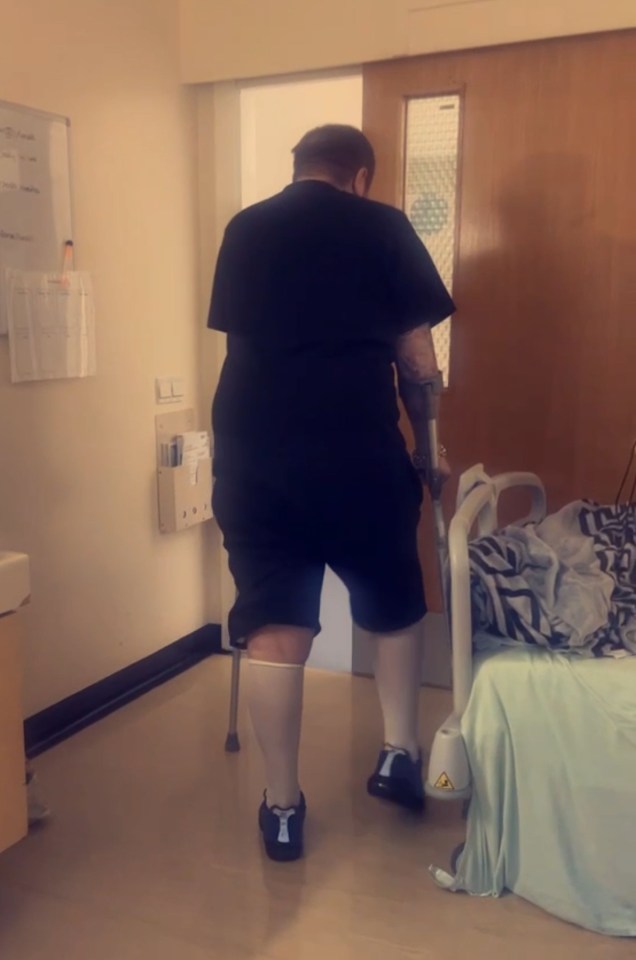 a man with crutches walks towards a hospital bed