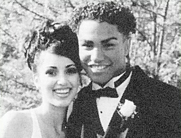 a black and white photo of a bride and groom posing for a picture .