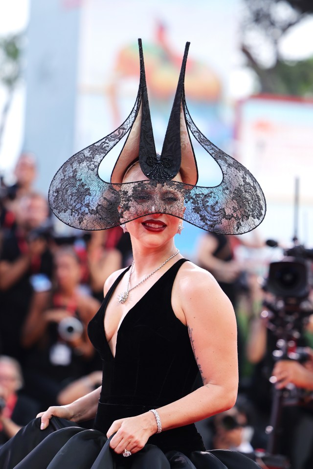 a woman wearing a mask and a black dress