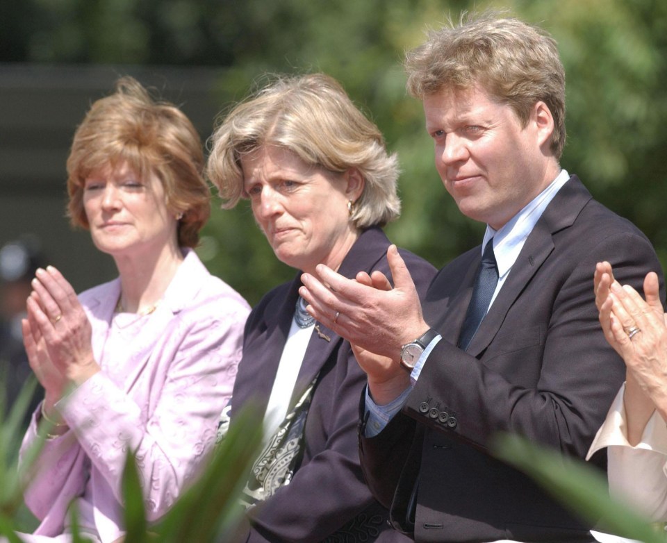 a man and two women are clapping their hands together